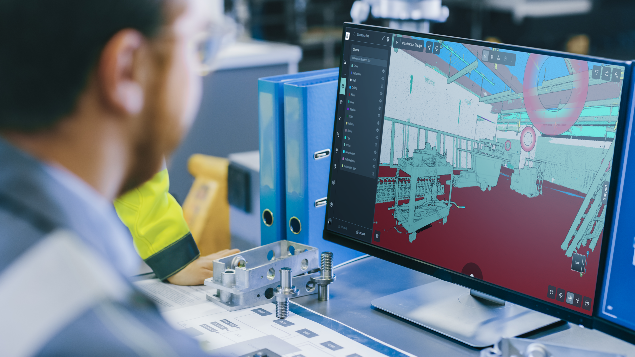Man at desk using Hexagon GeoCloud on a desktop computer